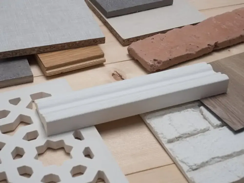 White baseboard moulding and flooring trim samples arranged for a Vacaville flooring project